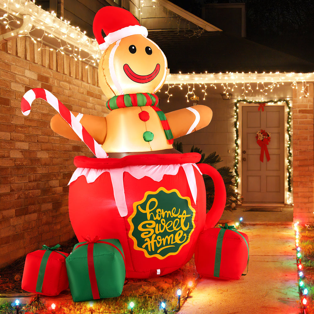 7-foot inflatable gingerbread man in hot cocoa mug with LED lights and gift boxes, perfect for Christmas yard.