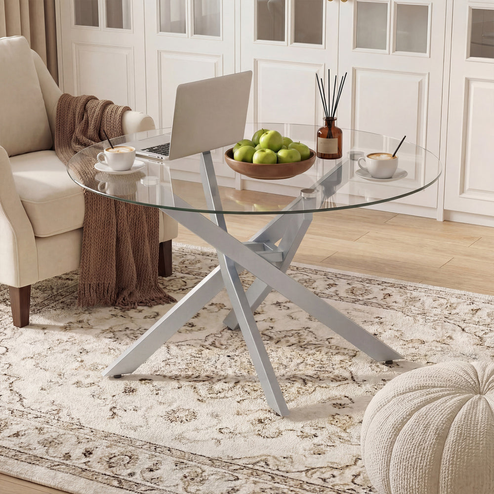 Round glass coffee table with a silver geometric metal frame, perfect for modern living spaces and easy maintenance.