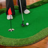 Golf practice putting green mat with realistic turf, featuring three holes and a golf ball for indoor or outdoor use.