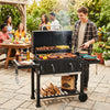 Large charcoal grill with integrated bottle opener and easy-to-grip handles, ideal for outdoor barbecue preparation.