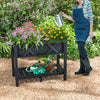 Elevated black HIPS raised garden bed with vibrant flowers, perfect for cultivating plants without bending or kneeling.