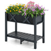 Elevated black HIPS raised garden bed with vibrant flowers, featuring a slatted shelf for gardening accessories.