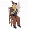 Eerie Halloween animatronic sitting scarecrow with glowing red eyes, candy bowl, and sound-activated spooky features.
