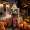 Halloween animatronic scarecrow with glowing red eyes, a cauldron candy bowl, and a wide base for stable outdoor placement.