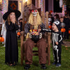 Eerie Halloween animatronic sitting scarecrow with glowing red eyes and candy bowl, perfect for trick-or-treaters.