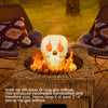 Realistic beige skull fire pit decoration with flames escaping from eyes, perfect for Halloween ambiance and spooky.