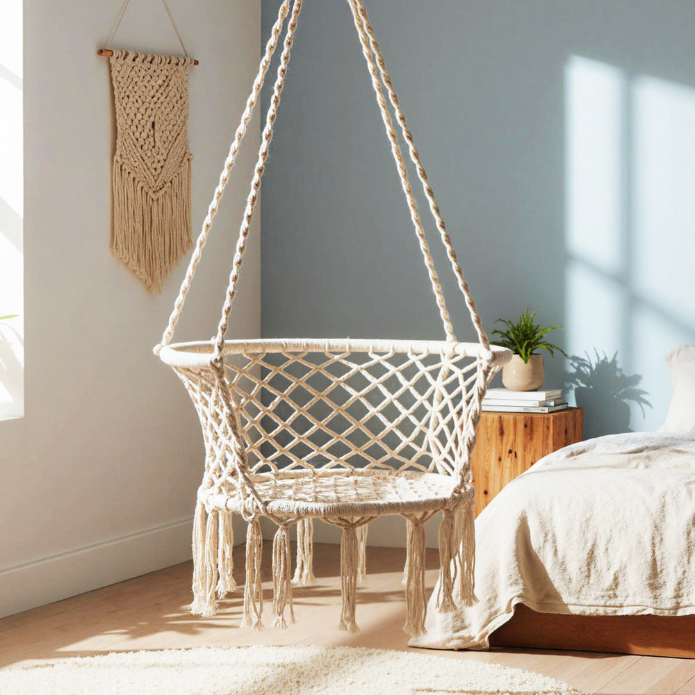 Macrame hammock chair in beige with elegant fringe, perfect for relaxing in your bedroom or balcony.