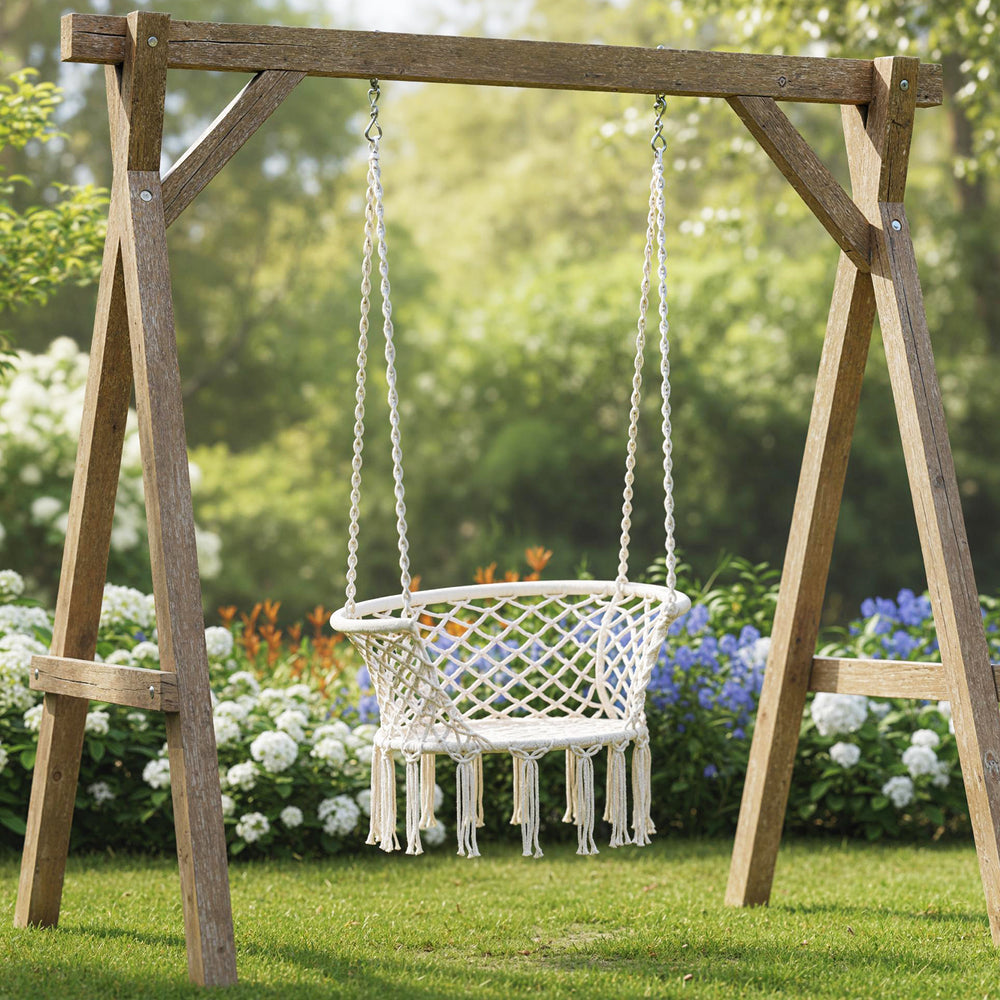 Macrame swing hanging chair in beige with sturdy frame and elegant fringe, perfect for porch or balcony relaxation.