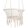 Macrame swing chair in beige with elegant fringe, made of cotton rope and metal rings, perfect for indoor or outdoor.