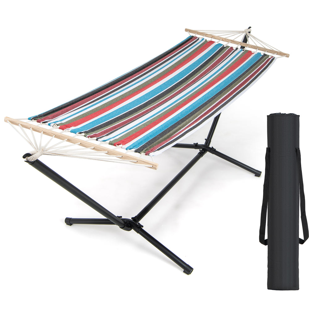 Multicolor hammock with heavy-duty metal stand, carrying case, and hand-woven ropes for outdoor relaxation.