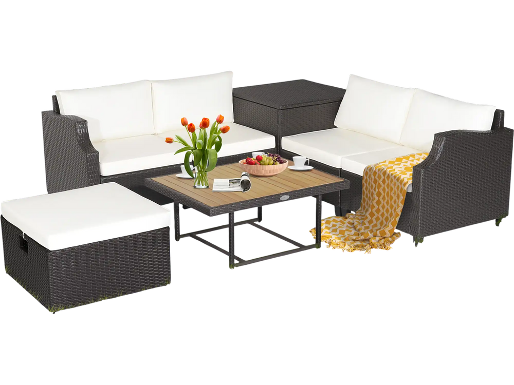 7-piece hand-woven wicker outdoor furniture set with white cushions and acacia wood coffee table for backyard.