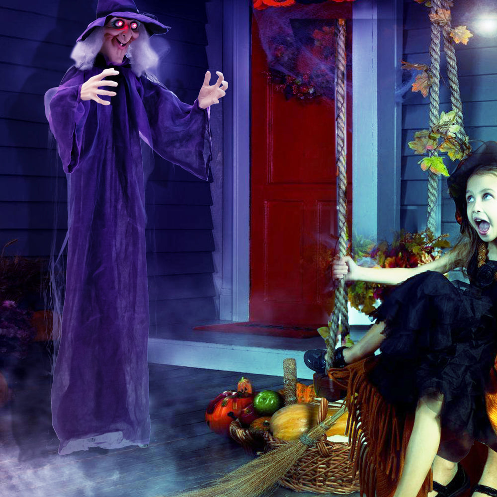 Life-size animated witch decoration with glowing red eyes and posable arms, perfect for Halloween indoor or outdoor use.