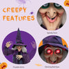 Life-size animated witch decoration with spooky face, posable arms, and glowing red eyes for Halloween scares.