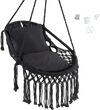 Hanging hammock chair in black with soft cushions, tassels, and sturdy rope chain, ideal for indoor and outdoor use.