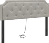 Tufted gray upholstered headboard with rubber wood legs, featuring charging ports, for queen and full size beds.