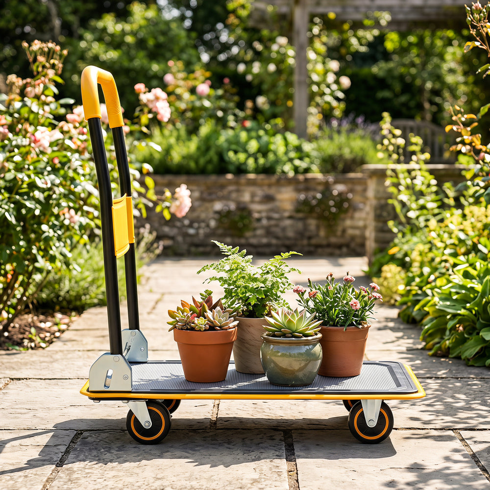 Heavy duty foldable push cart dolly in yellow with potted plants, featuring a 560 lbs weight capacity for versatile use.
