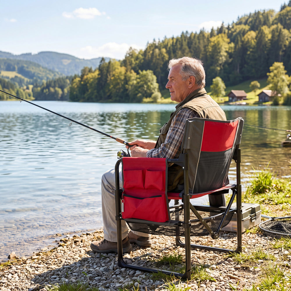 Heavy-duty outdoor camping chair in red with cup holder and side pocket, perfect for fishing and relaxation by the lake.