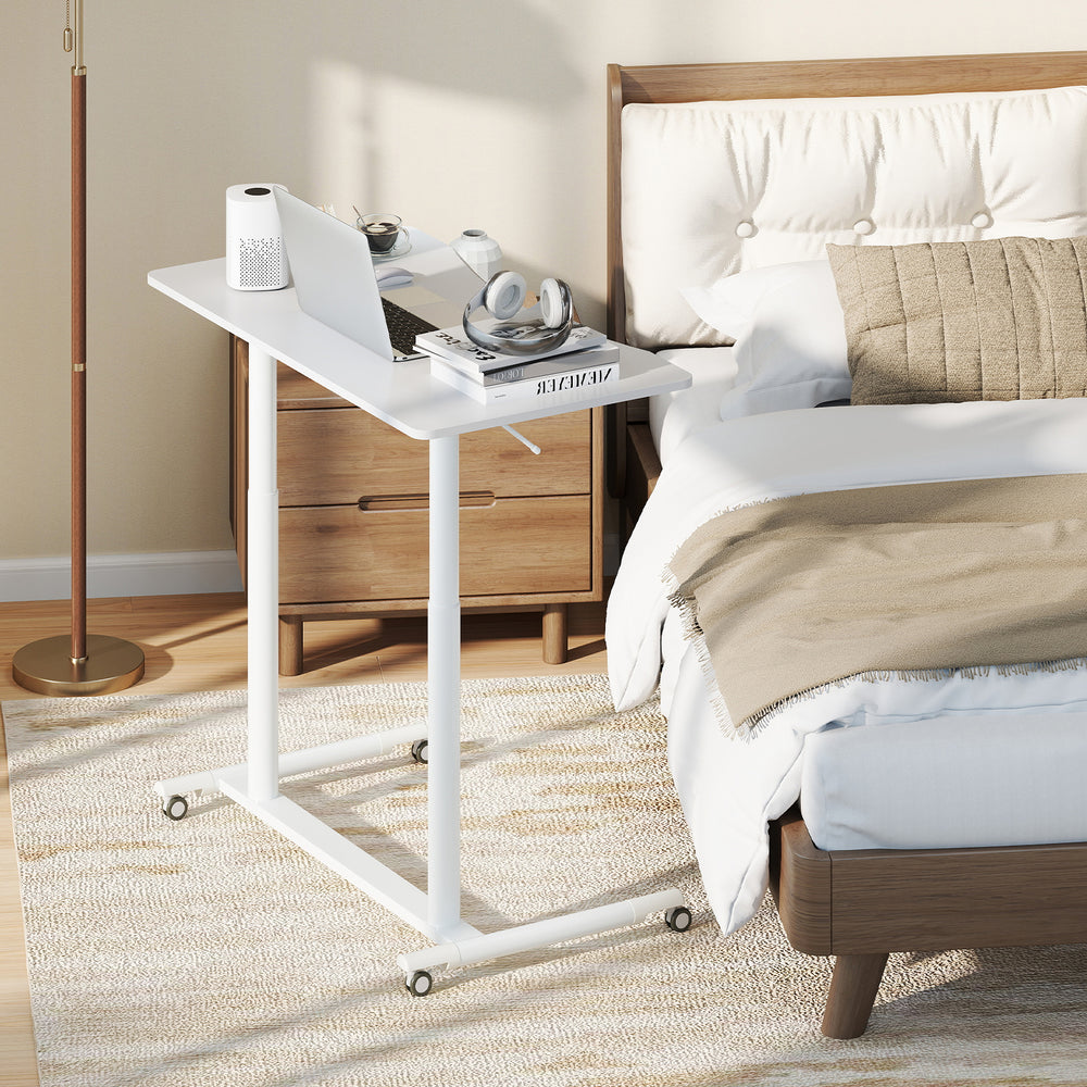 Height adjustable rolling table with a sturdy MDF top and steel frame, perfect for home office or bedside use.