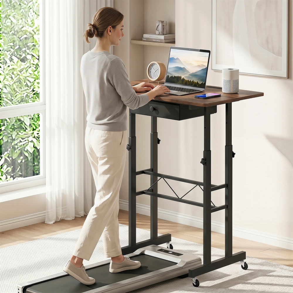 Height adjustable laptop desk in rustic brown with a fabric drawer, ideal for switching between sitting and standing.