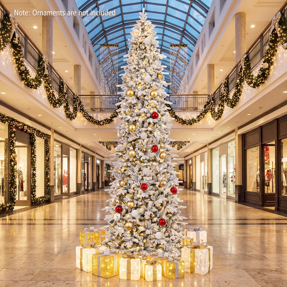 12 ft hinged artificial spruce Christmas tree featuring vibrant PVC leaves and warm white LED lights for a dazzling holiday look.