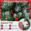 Close-up of snowy branch tips on a 6.5 ft hinged Christmas tree, featuring fireproof PVC and vivid red berries.