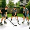 Three young players practicing hockey on synthetic ice tiles, showcasing realistic puck handling and shooting skills.