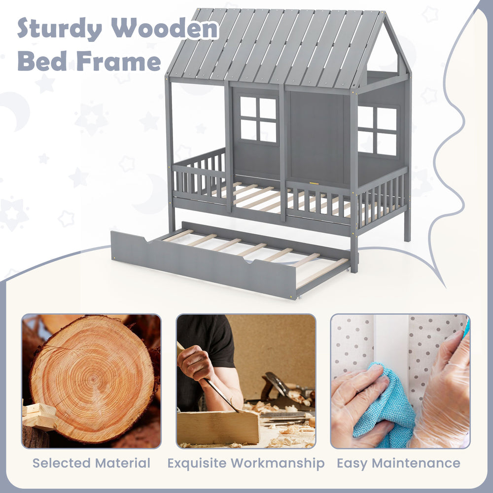 Twin size gray wooden house bed frame with trundle, featuring a tall roof and safe surrounding fence rails for kids.