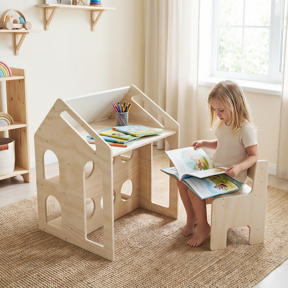 House-shaped wooden kids table and chair set in natural finish, ideal for reading and creative play in a cozy room.