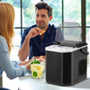Countertop ice maker in black producing bullet-shaped ice, ideal for home kitchen or party use, with self-cleaning.