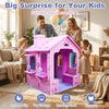 Indoor cottage playset in pink and purple with roof and chimney, featuring storage shelves for creative play.