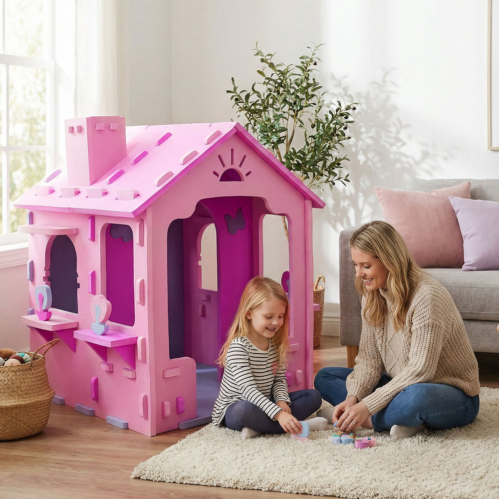 Indoor cottage playset in pink and purple with chimney, featuring two shelves for toys, perfect for creative play.