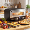 Countertop electric pizza oven in black, designed for 12-inch pizzas with dual knobs and a tempered glass window.