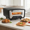 Indoor electric pizza oven with dual heating zones, 850℉ max temperature, and 8 presets for easy cooking of 12-inch pizzas.