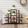 Multi-tiered brown wood plant stand with 6 shelves, displaying potted plants for indoor and outdoor use.