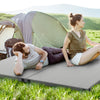 Foldable indoor outdoor sleeping mat with high-density foam, shown in use at a campsite for comfortable relaxation.