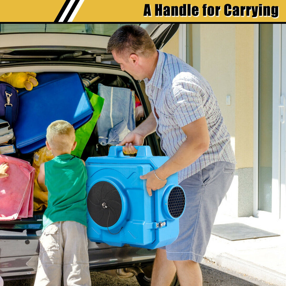 Portable industrial air scrubber in blue being carried, featuring a two-stage filter system for effective odor.