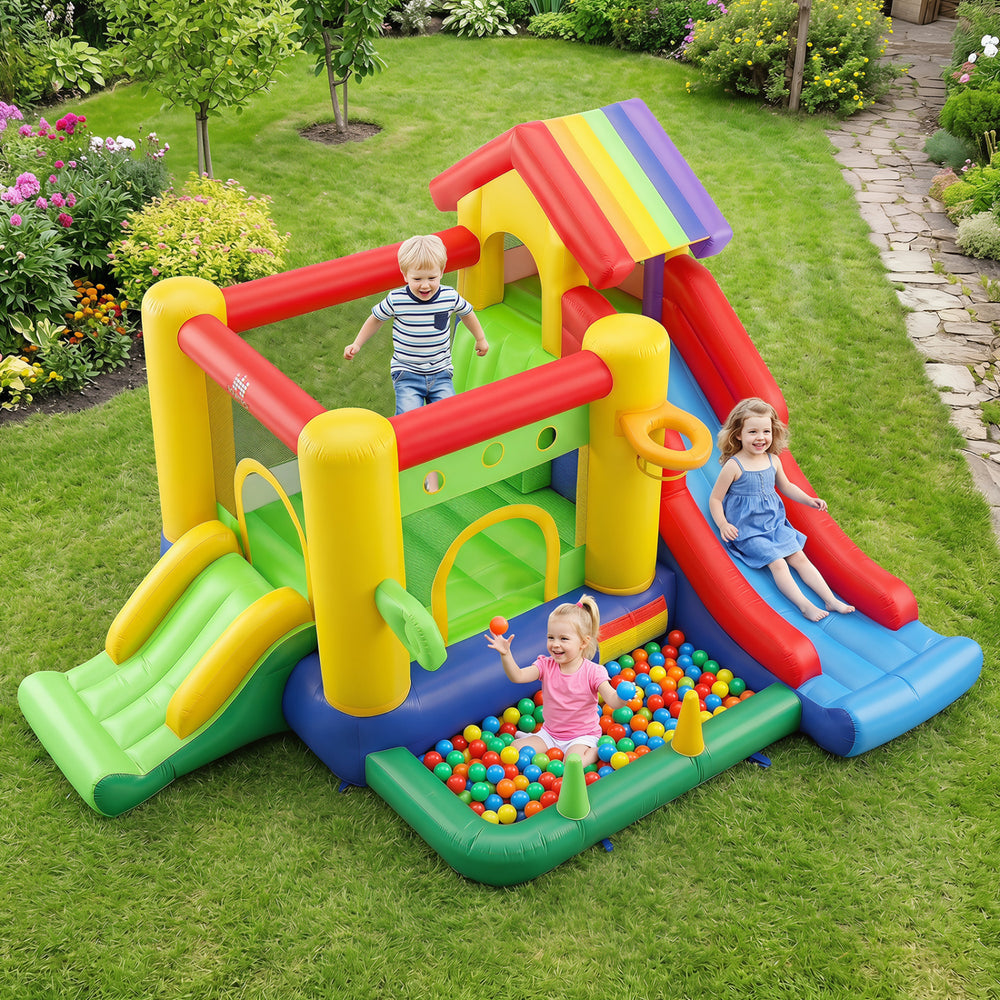 Colorful inflatable bounce castle with double slides, climbing wall, and ball pool for outdoor fun and playtime.