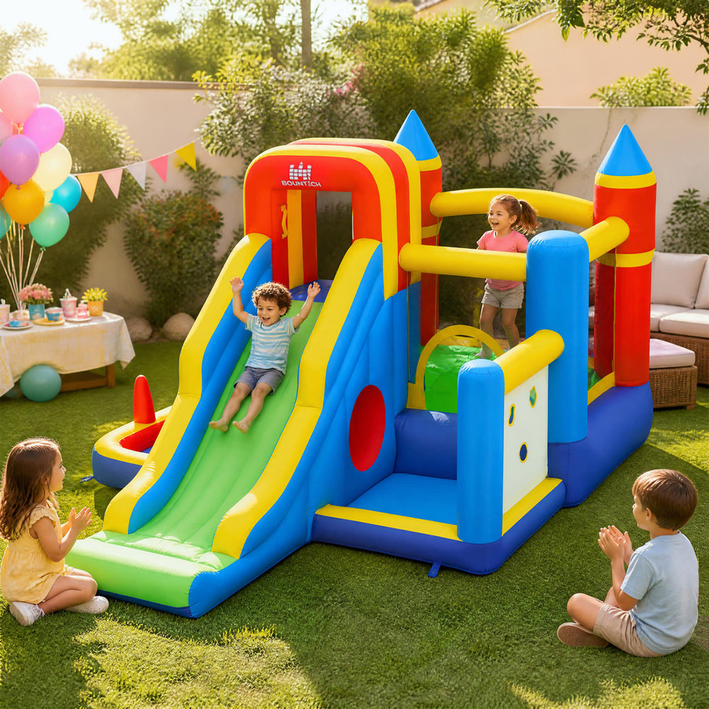 Colorful inflatable bounce house with slide, climbing wall, and basketball hoop for kids' outdoor fun and safety.