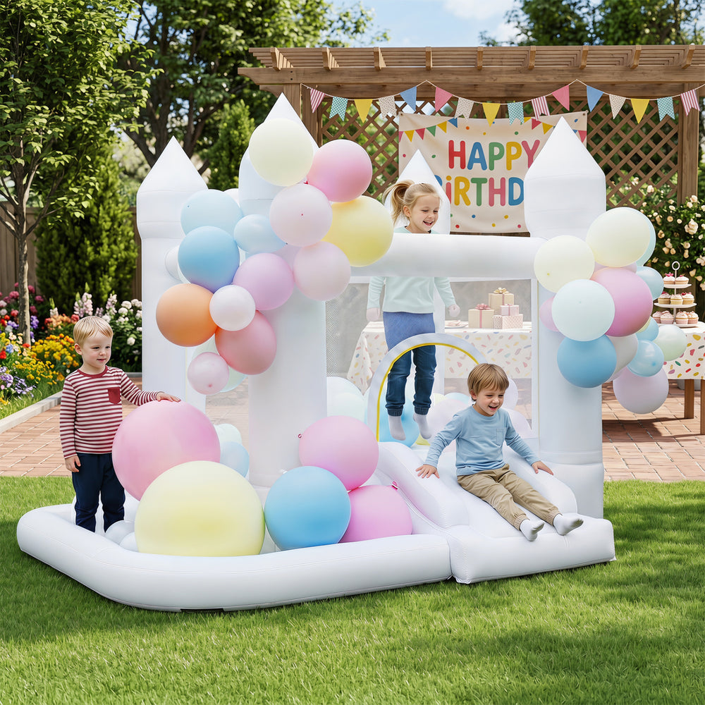 Inflatable bounce house with colorful balloons, slide, basketball hoop, and mesh walls for safe outdoor fun.