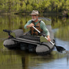 Inflatable fishing float tube in green with shoulder straps, storage bags, and rod holder for comfortable angling.