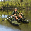 Inflatable fishing float tube in green showcasing the adjustable footrest and removable padded seat on the water.