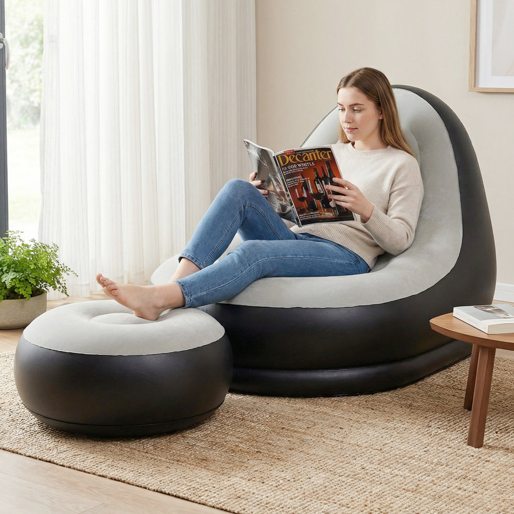 Inflatable lounge sofa with ottoman in grey, featuring a flocked surface, ideal for home or outdoor relaxation.