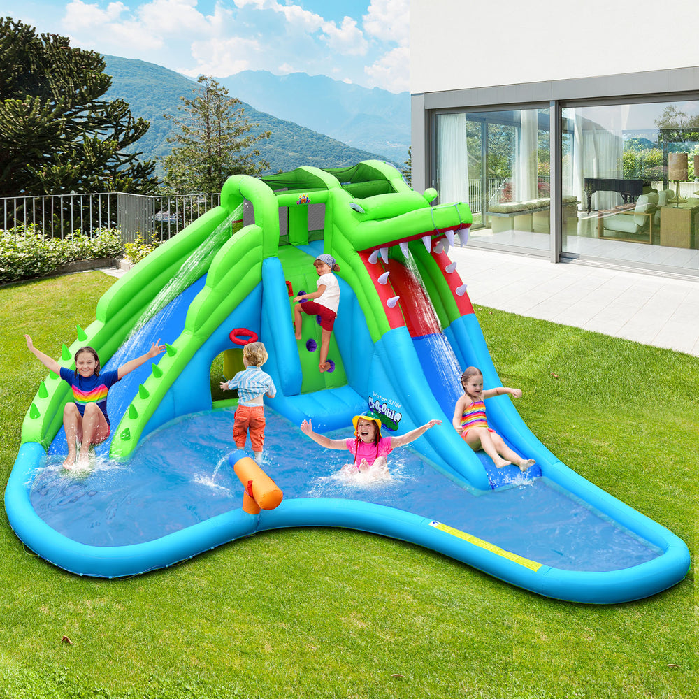 Kids climbing the inflatable crocodile water slide with bright green and blue colors, featuring a splashing pool for.