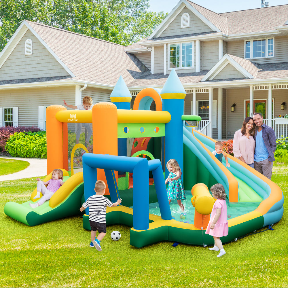 Inflatable water slide bounce house with dual slides, splash pool, and colorful accessories for outdoor summer fun.