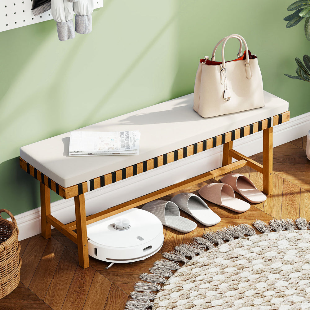 Acacia wood outdoor bench with thick padded seat cushion, ideal for garden or entryway seating.