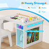 Kids art table and chair set in white with 4 removable paint cups and 2-tier storage for books and toys.