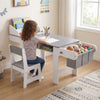 Kids art table and chair in gray with paper roll, fabric bins, and ample storage for drawing and studying activities.