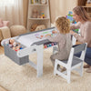 Kids art table and chair set in gray with paper roll, fabric bins, and ample storage for drawing and playing activities.
