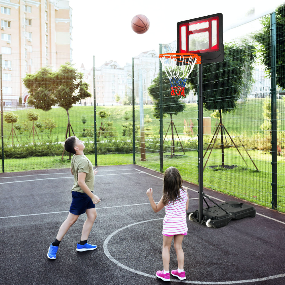 Children playing basketball with a 4.3-8.2 FT adjustable hoop featuring wheels for easy mobility and a shatterproof.