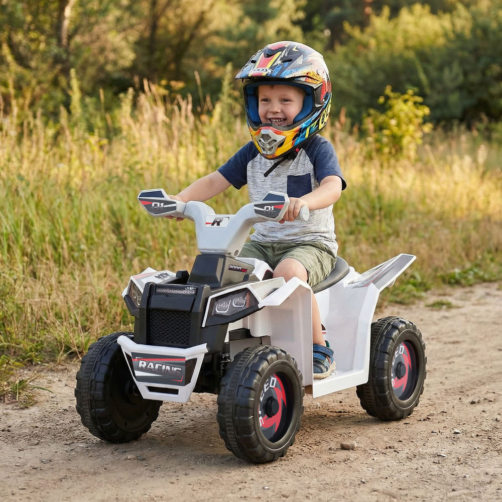 Child riding the 6V Kids Electric ATV Quad Car in white with a detachable trailer, enjoying outdoor adventure and fun.